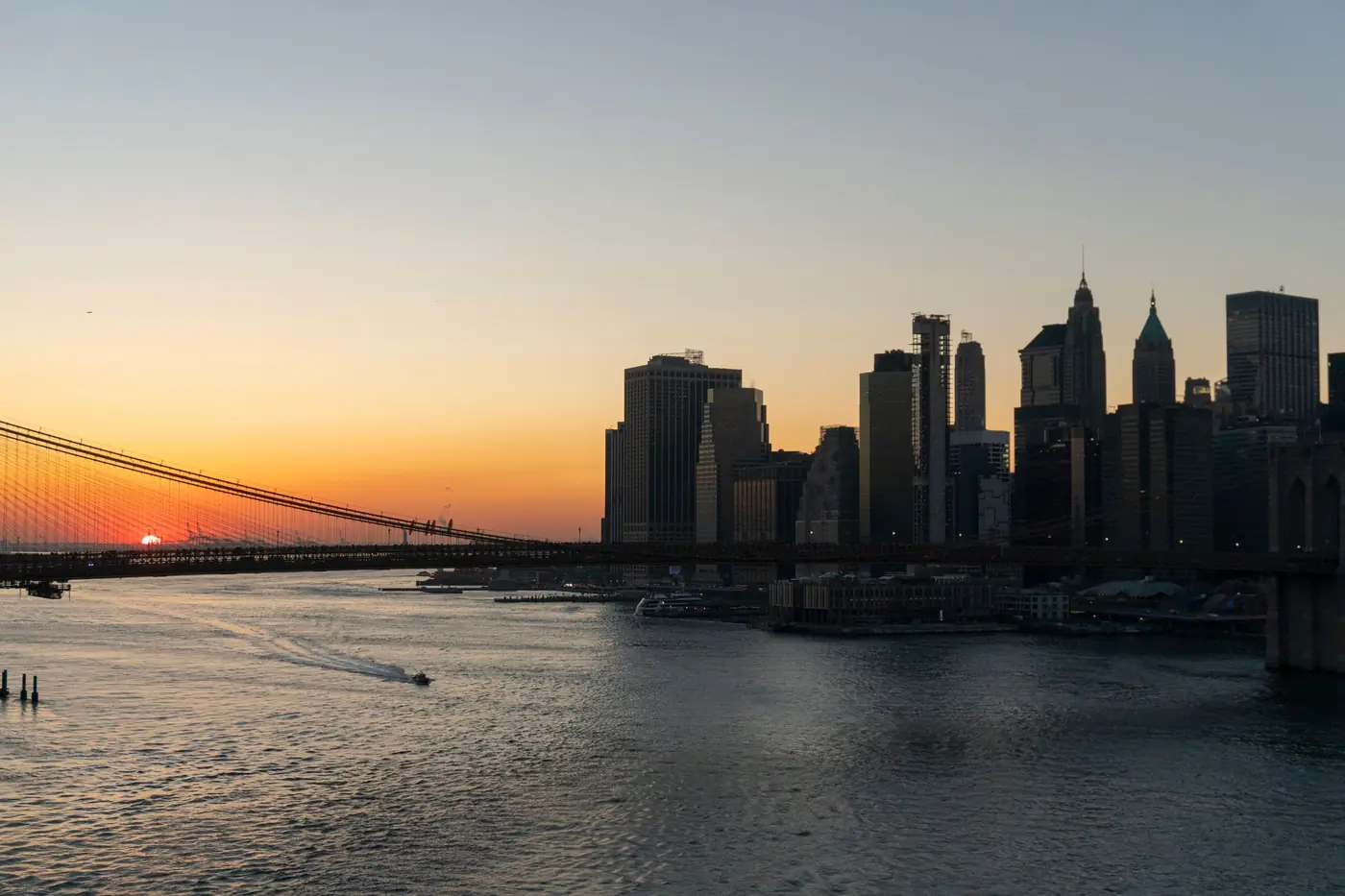 Manhattan skyline and Brooklyn Bridge in New York at sunset